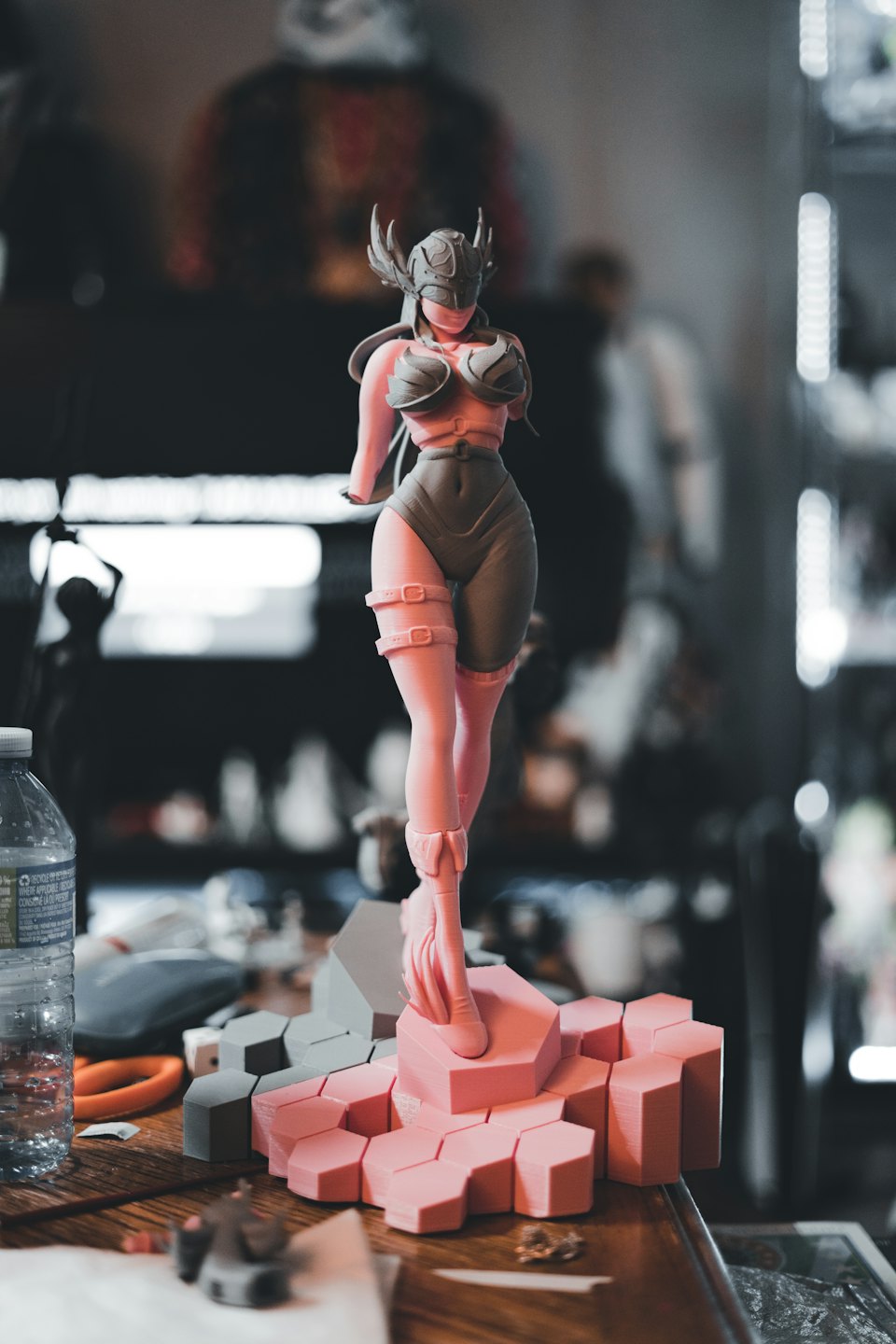 Partially assembled winged 3D printed figurine on a wooden workbench.